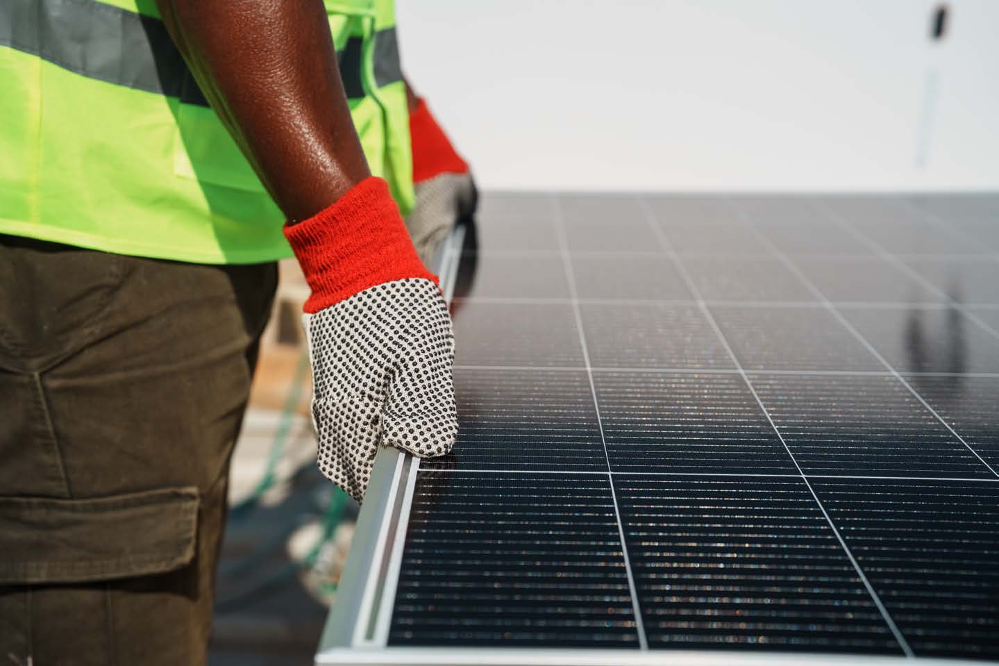 Installer handling a solar module at Lotustex